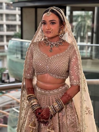 The bride with her dupatta set over the floral bun, ready for her ceremony.