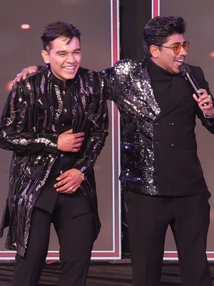 Sharing a laugh with the groom on stage. My goal is to make the couple feel comfortable and happy, creating genuine moments of joy that are beautifully captured.