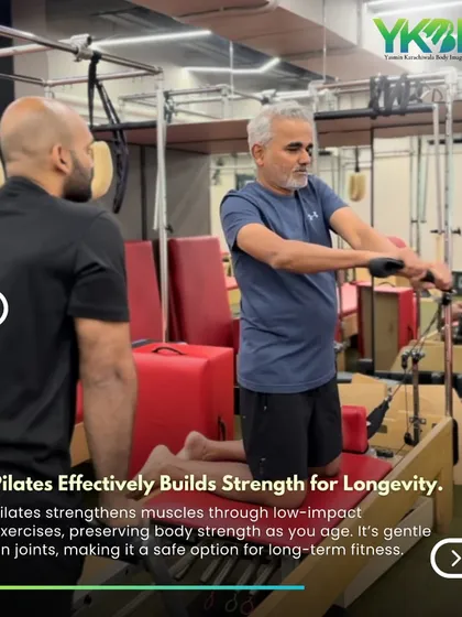 Pilates effectively builds strength for longevity. Here, a trainer guides an older client through a reformer exercise, demonstrating the low-impact approach that preserves joint health.