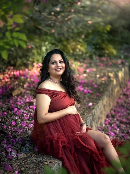 A serene portrait of the mother-to-be, sitting amongst a carpet of flowers, looking absolutely radiant.