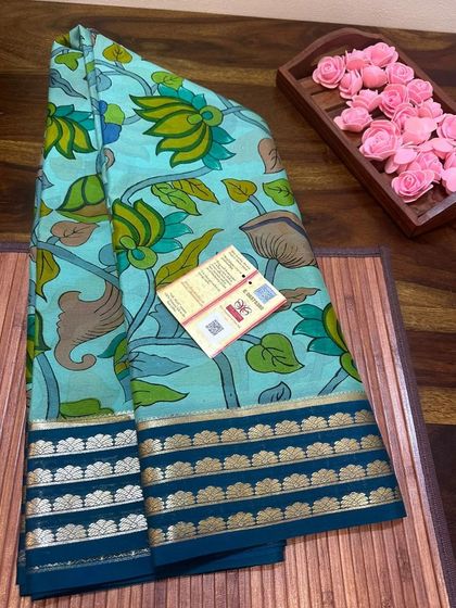 A serene blue-green lotus Kalamkari print on a Mysore silk saree with a dark teal border.