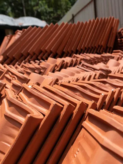 This image shows the red mission tiles, locally known as Mangalore tiles, stacked and ready for installation at Tellado Villas. Our commitment to using local, sustainable materials is a core part of our design philosophy, grounding our projects in their context.