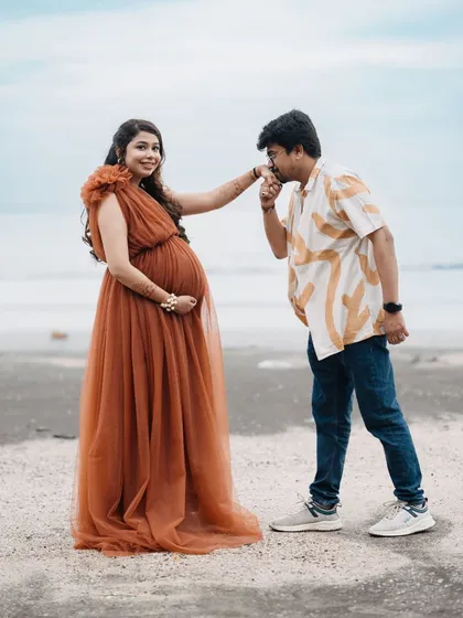 A tender moment on the beach. This couple's photoshoot feels so natural and romantic. She is wearing my one-shoulder rust-colored tulle gown, which moves beautifully in the sea breeze.