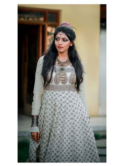 A close-up of the model in the layered block-print Anarkali, focusing on the unique neckline and bodice embroidery.