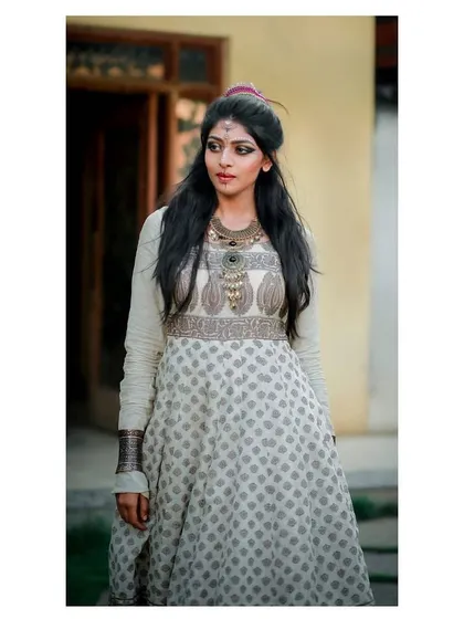 A close-up of the model in the layered block-print Anarkali, focusing on the unique neckline and bodice embroidery.