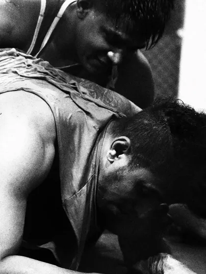 Close-up on the grind of a wrestling exchange. This is a battle of will as much as it is a battle of strength. Every inch is fought for.
