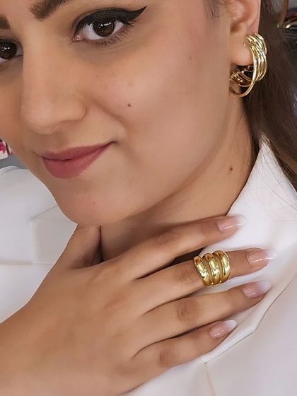 White is my power game. Here I am styling a crisp white blazer with our bold, multi-hoop gold-tone earrings and a matching ring for a look that is both powerful and chic.