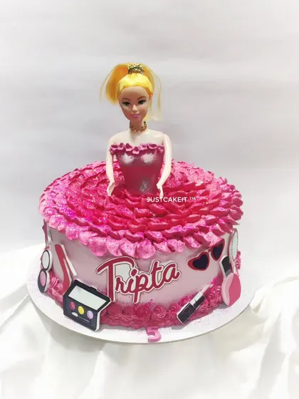 A classic Barbie doll cake with a modern twist. The doll is surrounded by an edible dress made of pink frosting, and the cake is decorated with fun, edible makeup accessories.