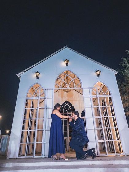 A perfect proposal shot captured at our signature white chapel set. This angle showcases the full grandeur of the backdrop, making it an ideal spot for capturing key moments in your love story.