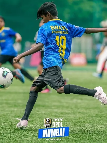 The journey to greatness begins with a single kick. A player strikes the ball with power and precision.
