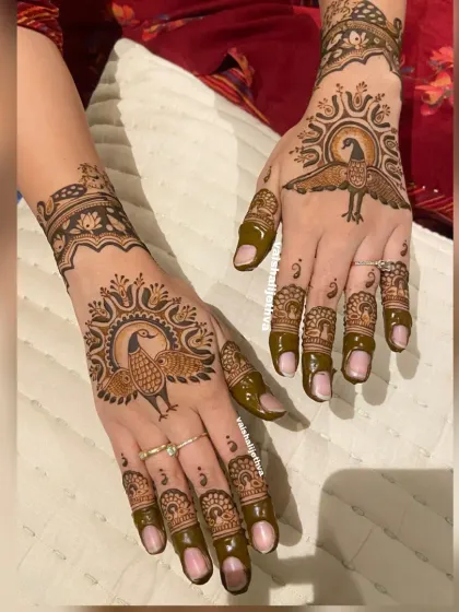 Another angle of the royal peacock design. The spread wings of the peacock create a dramatic and eye-catching effect on the back of the hand.