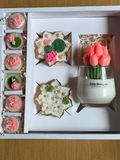 Another view of the large corporate gift box, showing the beautiful arrangement of the tulip candle, urli candles, and smaller floral candles.