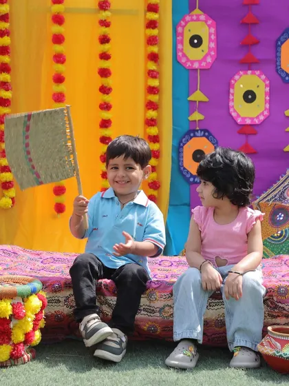 A happy moment captured during our Baisakhi festival event. The colourful backdrop and traditional props create an immersive cultural experience for the children.