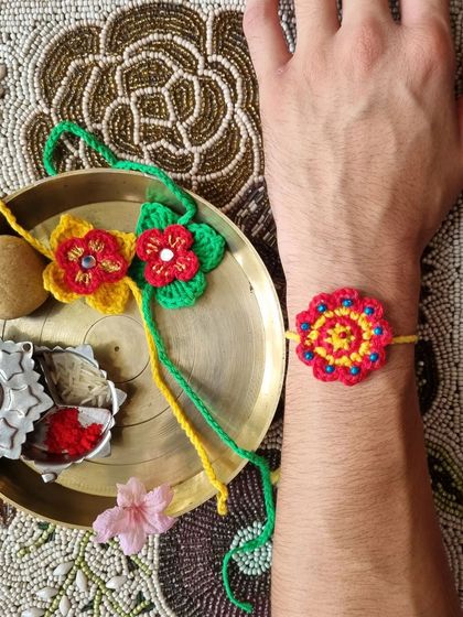 Our handmade rakhi tied on the wrist, sitting next to a traditional puja thali. It's a beautiful blend of modern craft and timeless tradition.