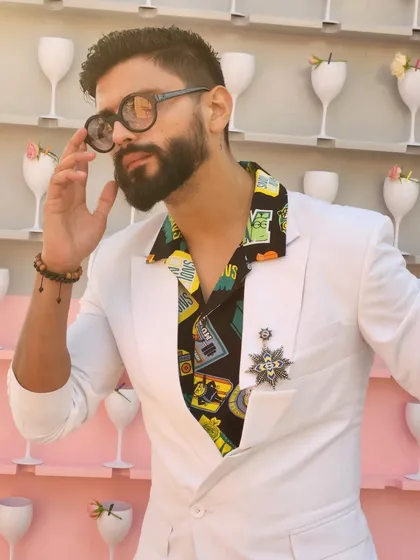 A quirky and stylish look with a printed shirt under a white blazer. It's all about seeking the magic in everyday style.