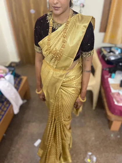 A full-length shot of the beautiful golden saree.