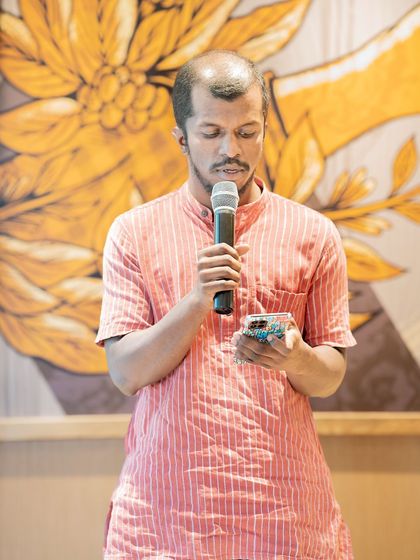 A poet performs at our "Voices of the Nation" themed event. This gathering celebrated India's Independence Day through poetry and stories.