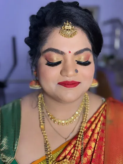 A close-up of the glittery eye makeup for the naming ceremony, showing the blend of gold and copper tones.