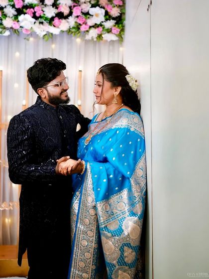 A sweet moment between the couple. The bride's makeup is perfectly balanced for professional photography.