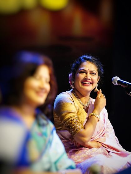 A candid shot capturing a moment of joy between performers on stage.