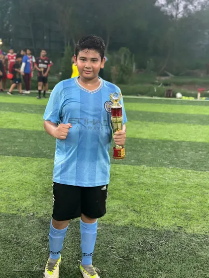 A look of accomplishment from one of our players as he poses with his tournament trophy.