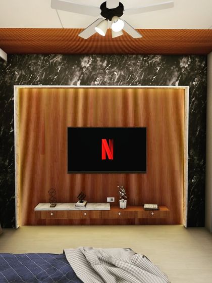 The entertainment wall in the master bedroom uses a dramatic, dark marble-look panel as a backdrop for the wood-paneled TV mount. This creates a bold contrast and a luxurious feel.