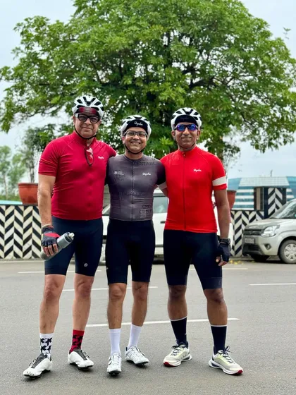 Three friends in matching red and black kits, showing the unity of our team.