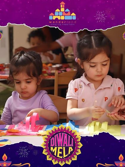 Two girls concentrate on their paper crafts at the Diwali Mela. We ensure there are plenty of engaging, hands on activities that allow children to be creative and make something special.