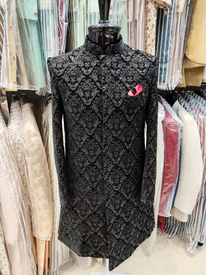 For a truly luxurious feel, I designed this sherwani using black velvet with heavy silver embroidery in an intricate damask pattern. The pop of a pink pocket square adds a touch of modern flair.