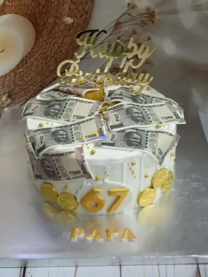 A cake that looks like a million bucks, or at least a few thousand rupees. This money-themed cake is decorated with edible currency notes for a 67th birthday.