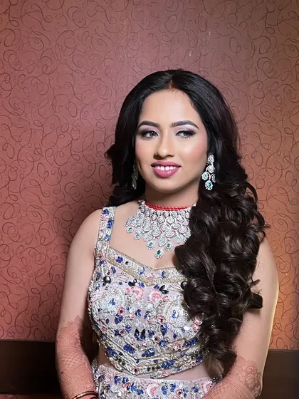 An elegant reception look for a lovely client. I opted for soft, romantic curls and a makeup look that enhanced her features with a pop of color on the lips and shimmering eyes.