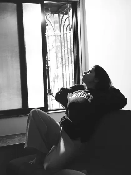 A beautiful, contemplative black and white portrait, using the soft light from a window.