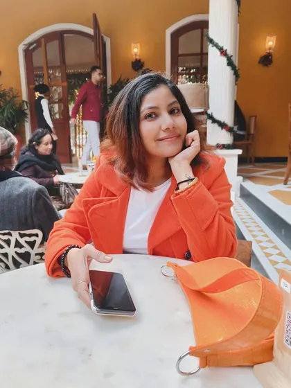 A smiling portrait in the same orange coat, conveying a happy and approachable vibe.