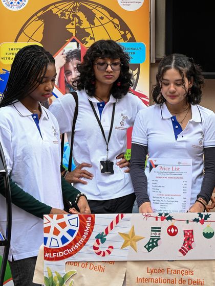 Students at a booth during the Christmas Mela. This image showcases the festive spirit and student involvement that characterize our seasonal events.
