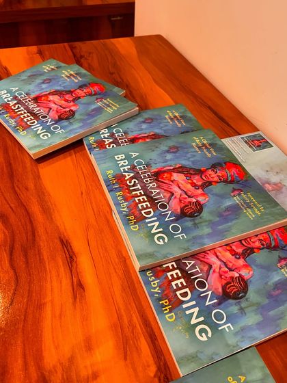 Copies of the book 'The Celebration of Breastfeeding' at our studio event. We are proud to provide a venue for authors to launch their work and engage with readers.