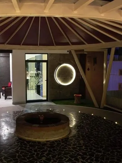 The outdoor fire pit area of our Bangalore centre, beautifully lit at night. This space is central to many of our powerful fire meditation and Havan ceremonies.