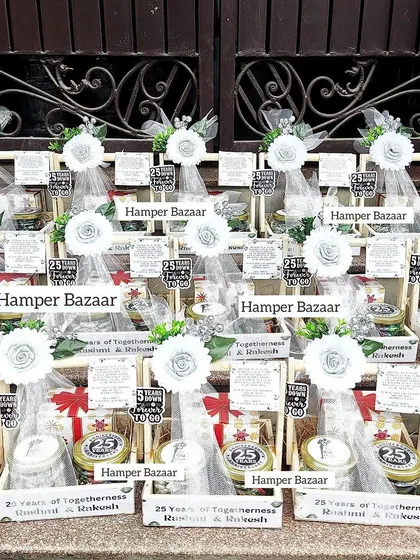 A whole array of our Silver Jubilee hampers, ready for the celebration. Each one includes a customized mug and jars of truffle chocolates and paan kishmish.