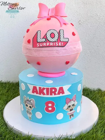 This LOL Surprise cake is a party in itself, featuring a real piñata cake on top of a themed base cake. The piñata is a chocolate shell filled with treats.