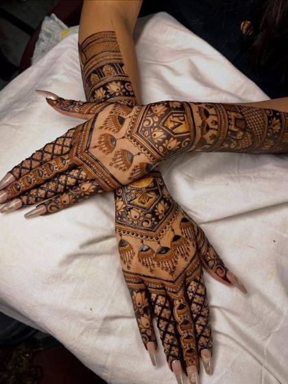 A creative pose showing the beautiful symmetry of our back-hand designs. The peacock and geometric motifs are perfectly mirrored on both hands.