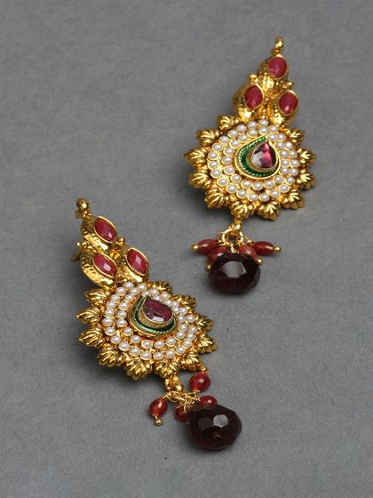 These small, gold-plated danglers with red stones and pearls are part of our affordable daily wear collection.