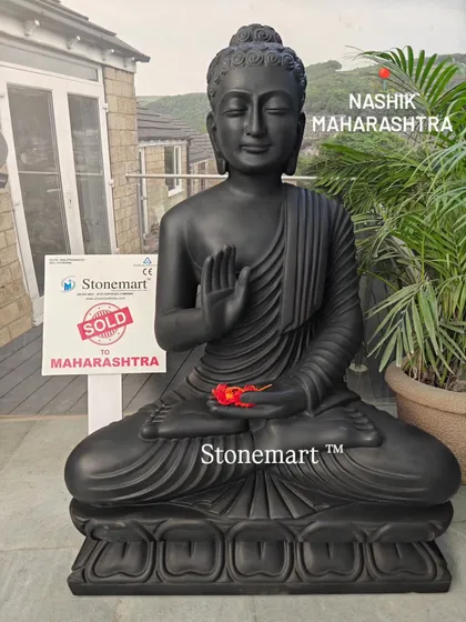This image highlights the contrast between the dark, smooth marble and the bright flower, showcasing the statue's potential as a decorative centerpiece.