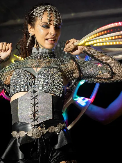 A close-up of the intricate, sparkling costume and multi-colored LED fans. We pay close attention to detail to ensure our look is as impressive as our performance.