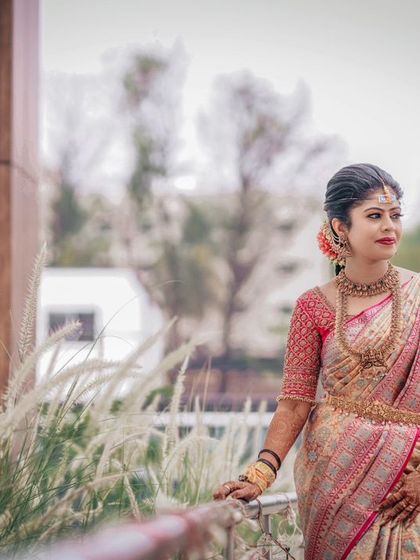A bride posing on a balcony, with the soft outdoor light creating a beautiful, dreamy effect.