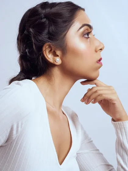A profile view highlighting the clean, glowing skin and the intricate detail of the bubble braids.
