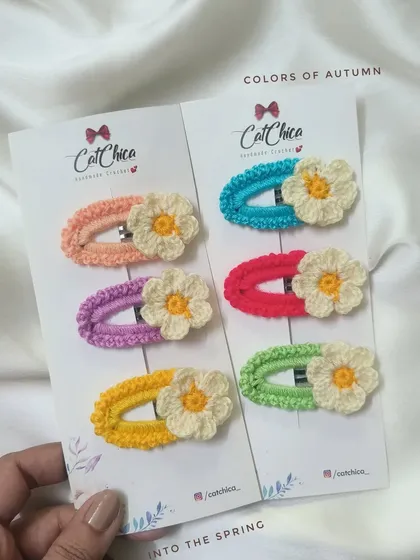 Another look at our daisy-adorned barrettes, available in a variety of spring and autumn color palettes.