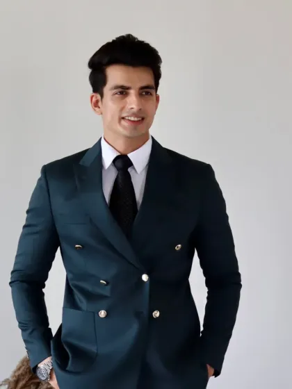 A well-tailored suit is a symbol of confidence. This deep teal double-breasted suit, finished with polished silver-tone buttons, is designed for moments that demand presence, whether in the boardroom or at a formal gathering.
