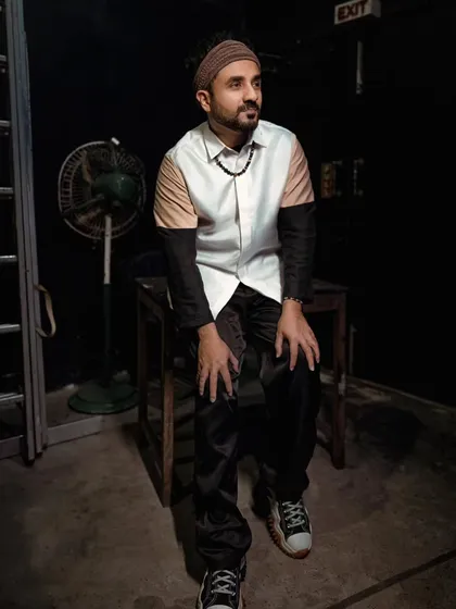 Another look we styled for Vir Das. This shot captures him in a thoughtful pose, wearing a unique color-blocked shirt from Maison Tai that perfectly matches his creative and intellectual vibe.