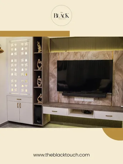 A well-designed entertainment and worship area. The TV unit features a marble-finish panel and is flanked by a beautiful mandir with jali-cut doors, blending modern needs with traditional values.