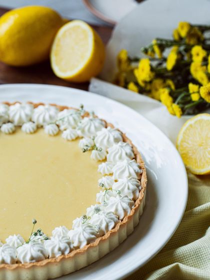 My classic Lemon Tart combines a buttery, flaky crust with a smooth, zesty lemon curd filling, all topped with delicate meringue kisses.