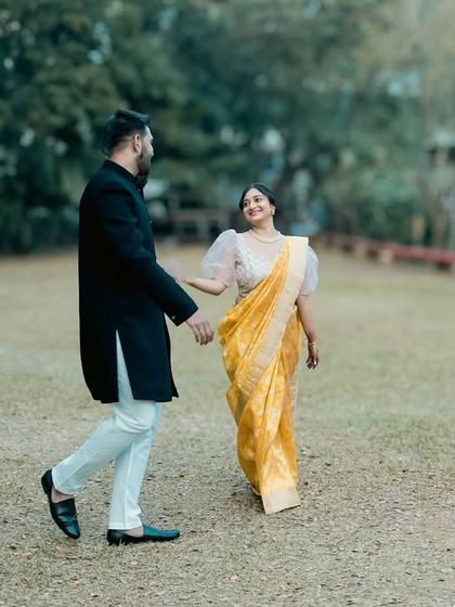 A candid, full-length shot of the couple enjoying a walk in the park. The movement and natural interaction make this photo feel alive and authentic.